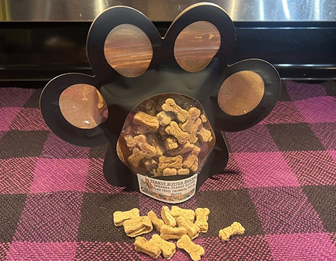 Peanut butter and bananas dog treats in new Bad Dog Bakery packages that are shaped like a paw print.
