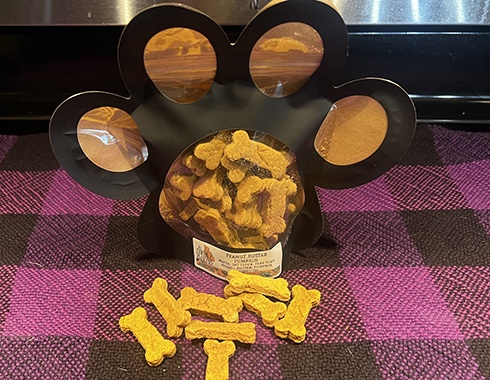 Peanut butter and pumpkin dog treats in new Bad Dog Bakery packages that are shaped like a paw print.
